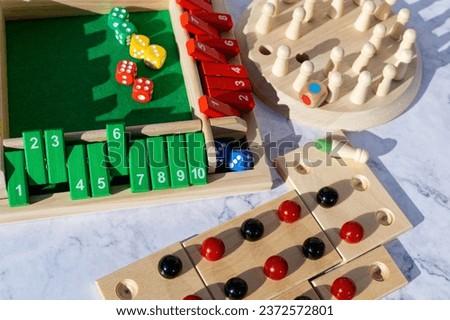 Different wooden board games with gaming accessories. Royalty-Free Stock Photo #2372572801