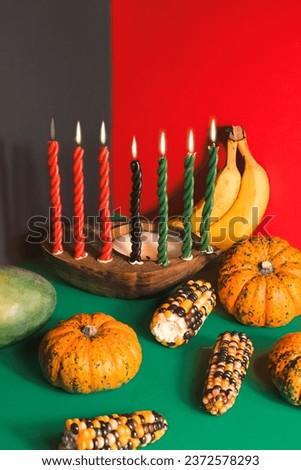 Kwanzaa, african holiday Kwanzaa with decoration of seven candles in red, black and green colors, vegetable harvest, corn. Greeting card banner. Happy Kwanzaa
