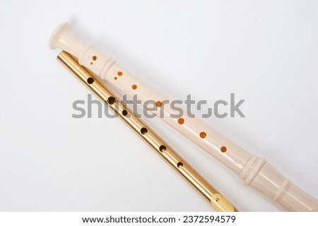 Irish whistle and block flute are longitudinal flutes with a whistle device and playing holes. Royalty-Free Stock Photo #2372594579