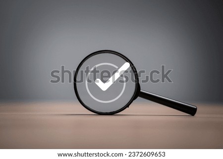 White correct sign symbol inside black magnifier glass for document and project approve , ISO quality assurance control concept.