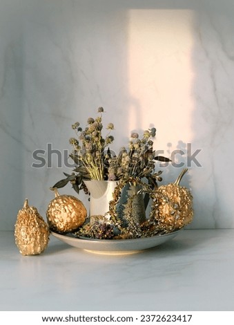 autumn composition with flowers bouquet and decorative pumpkins on table. cozy style floral decoration for fall season.