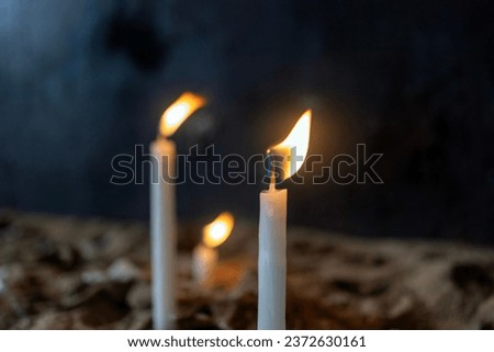 white candles are burning. Candles lit to make wishes.