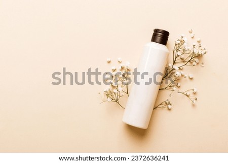 Fancy healthcare bottles for cream with gypsophila branch. Natural oranic spa cosmetics concept. Mockup, template, Top view. Royalty-Free Stock Photo #2372636241
