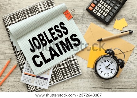 jobless claims . Business concept. open notepad on colorful notepad. calculator. a table clock Royalty-Free Stock Photo #2372643387