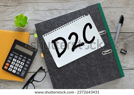 D2C.t ext on a notepad on a gray folder with documents
