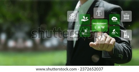 Businessmen touching on words environmental law. Concept of international law environmental protection, environmental impact assessment, Eco friendly law, business corporate and industry. Royalty-Free Stock Photo #2372652037