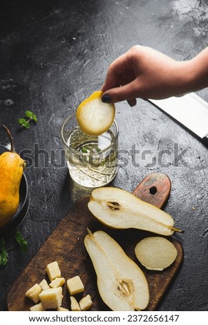 Girl preparing a cocktail with pear