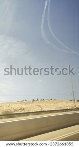 trace of a streak in the sky after a flight of downed missiles in the south of Israel, Negev, the beginning of the war October 7, 2023. High quality photo Royalty-Free Stock Photo #2372661855