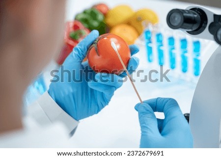 Scientist check chemical food residues in laboratory. Control experts inspect quality of fruits, vegetables. lab, hazards, ROHs, find prohibited substances, contaminate, Microscope, Microbiologist Royalty-Free Stock Photo #2372679691