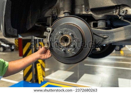 Close up view of a Maintenance Car service - auto oil change, motor check, brake cleaning, tire check, engine inspection, motor oil-brake inspection Royalty-Free Stock Photo #2372680263