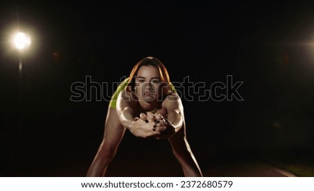 Pretty girl sportswoman doing exercises on a black background.