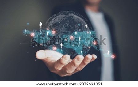 Businessman point at global online marketplace and reach for customer engagement with insight data analytic, business intelligence. SEO marketing big data strategy for worldwide omnichannel market. Royalty-Free Stock Photo #2372691051