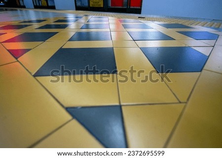 A tile flooring with squared-shaped arranged forming a beautiful decoration