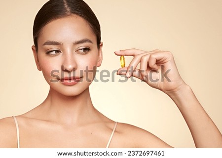 Vitamins. Close Up Of Happy Beautiful Girl With Pill With Cod Liver Oil Omega-3. Nutrition. Vitamin D, E, A Fish Oil Capsules. Healthy Lifestyle. Sport, Diet Concept Royalty-Free Stock Photo #2372697461