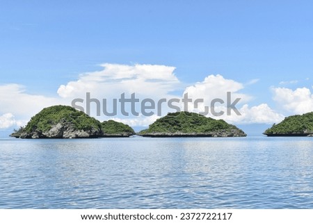 Blue sky and blue sea in a sunny day is good for island hopping. Royalty-Free Stock Photo #2372722117