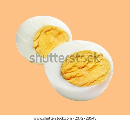Boiled egg isolated with clipping path, no shadow on cream background, chicken egg