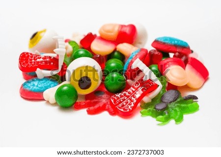 Trick or Treat Delights: Assorted Halloween Gummies - Fingers, Eyes, Spiders, Brains, Tongues, Bones on White Background