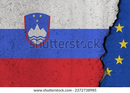 Slovenia and EU flag cracked on a concrete background