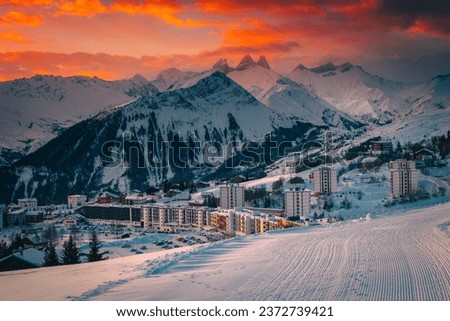Majestic winter mountain resort with modern buildings at sunrise, La Toussuire, France, Europe Royalty-Free Stock Photo #2372739421