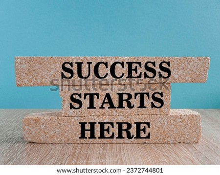 Success starts here symbol. Concept word Success starts here on beautiful brick blocks. Beautiful blue background. Business motivational success starts here concept. Copy space. Royalty-Free Stock Photo #2372744801