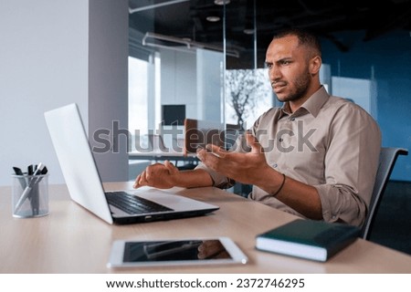 Upset frustrated businessman looking at laptop window, man received online notification message with bad achievement results, workplace error. Royalty-Free Stock Photo #2372746295