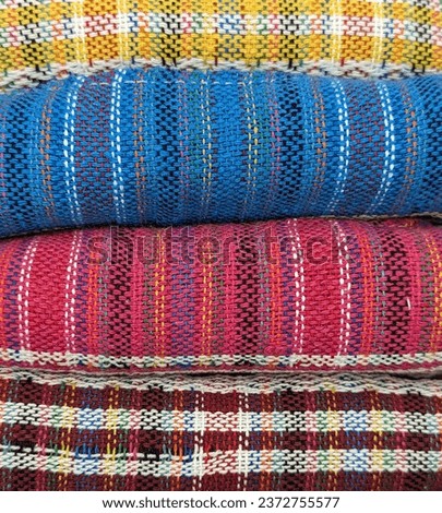 Mexican textiles in yellow, blue, pink and red color. Hand made