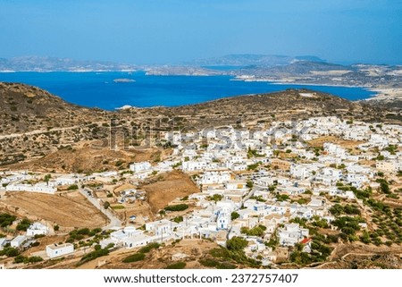 View of Plaka village with white houses and sea view from high vantage point, Milos island, Cyclades, Greece