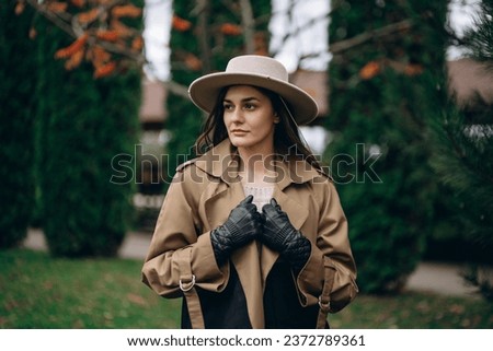 A young woman in a brown dress and hat. High quality photo