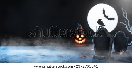 Close up of a tombstone in a cemetery. Copy space. Scary cemetery in fog at night by the light of the moon, crows, bats. Rising from the dead zombies. Halloween background. Cute