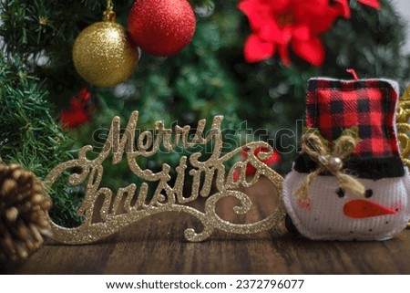 Merry Christmas sign with Christmas tree decorations. Christmas background, selective focus.