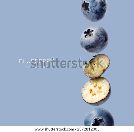 Creative layout made of blueberry on the blue background. Flat lay. Food concept. Macro concept.  Royalty-Free Stock Photo #2372812005