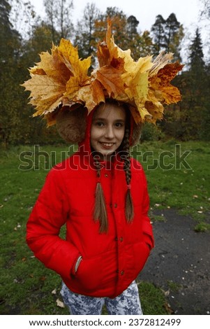 Girl with leaves on her head.