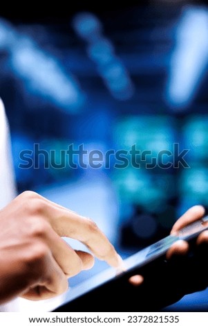 Adept engineer writing data center disaster contingency plan on tablet to provide rapid restoration of service, limit disruption and minimize interruptions to normal operations