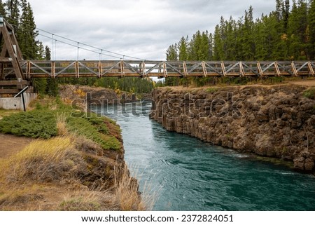 The Yukon River as it makes its way through Miles Canyon, just outside of Whitehorse, Yukon.  Pictured is the Robert Lowe suspension bridge.