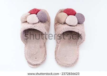 Old torn home slippers on white background