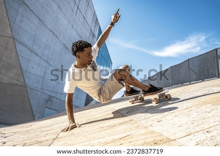 Surf skater training surfing moves on a urban scene. Royalty-Free Stock Photo #2372837719
