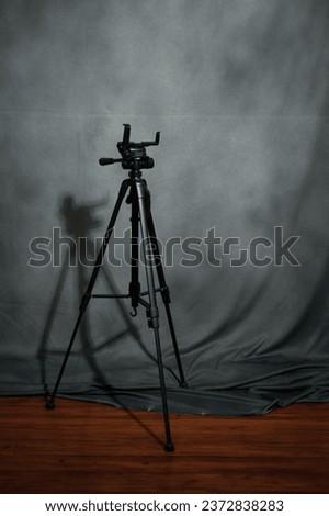 Selected focus photo from camera tripod with black cloth background