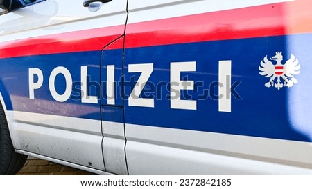 Police patrol car parked on the street in Vienna, Austria. Austrian police car on the street. Side view of a police car with the lettering "Polizei". 