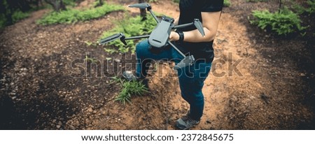 People hold drone in summer forest