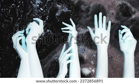 Negative effect. Psychedelic energy. Fantasy galaxy. Blue woman alien hands arms on dark glitter bubble fluid ink abstract background double exposure.