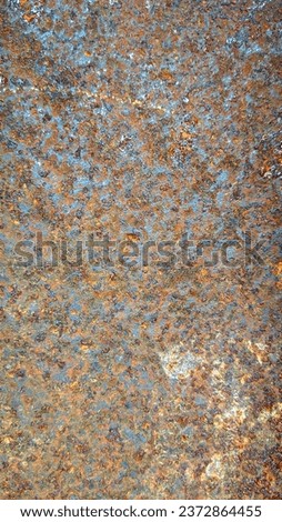 An image of an iron plate that is worn out and is undergoing a corrosion process, producing various motifs and colors.