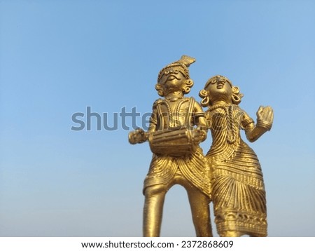 Elegant brass statue, a timeless work of art, gleaming in warm, golden hues, showcasing exquisite craftsmanship and cultural significance.