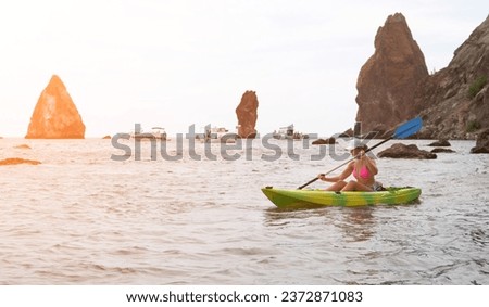 Woman kayak sea. Happy tourist enjoy taking picture outdoors for memories. Woman traveler posing in kayak canoe at sea surrounded by volcanic mountains, sharing travel adventure in kayak
