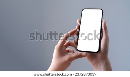 adult hands holding smartphone blank touch screen isolated on background.
