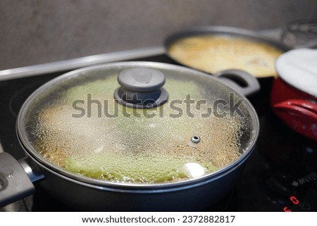 cooking pan on electric stove, electric stove is heated to red.  Royalty-Free Stock Photo #2372882817