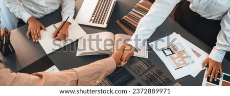 Interior designer shake hand with client or colleagues after made successful sketching and choosing mood board materials or color selection for modern house interior design. Insight Royalty-Free Stock Photo #2372889971