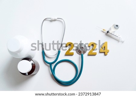 Golden wooden numbers 2024 and stethoscope, Happy New Year for health care.heart health, health insurance concept, new year resolutions goal.medicine treatment and yearly health checks.