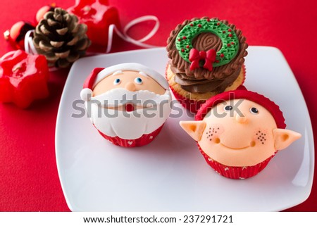 Three decorative Christmas cupcakes  on white plate
