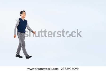 Walking Middle aged Asian man. Royalty-Free Stock Photo #2372936099