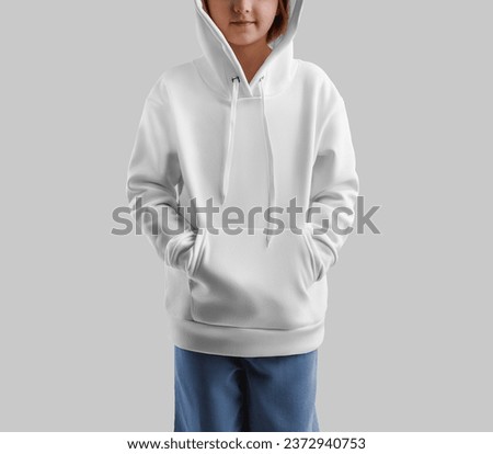 White hoodie mockup on girl with hands in pockets, casual wear for design, print, pattern. Template kid's long sleeve with a hood on a child in jeans, isolated on the background. Product photography